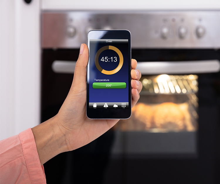 image of a phone using an app that controls an appliance in the kitchen